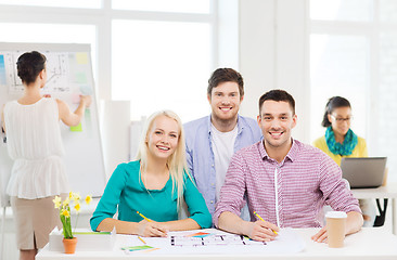 Image showing smiling interior designers working in office