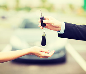 Image showing customer and salesman with car key