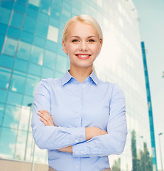 Image showing young smiling businesswoman with crossed arms