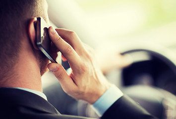 Image showing man using phone while driving the car