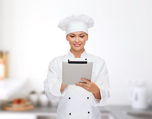 Image showing smiling female chef with tablet pc computer
