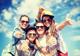 Image showing smiling teenagers in sunglasses hanging outside