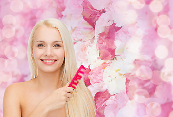 Image showing smiling woman with hair brush