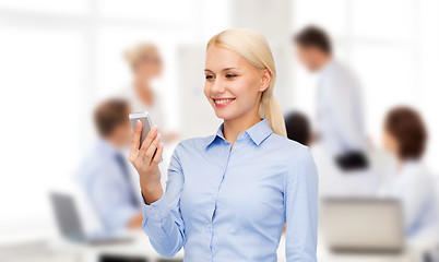 Image showing young smiling businesswoman with smartphone