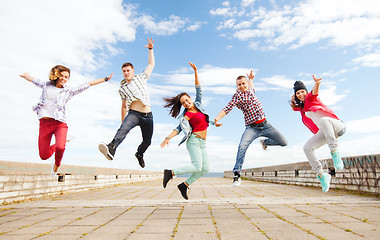 Image showing group of teenagers jumping