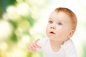 Image showing curious baby looking up