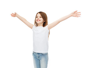 Image showing smiling teenage girl with raised hands