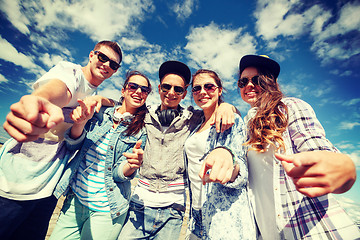 Image showing smiling teenagers in sunglasses hanging outside