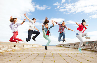 Image showing group of teenagers jumping