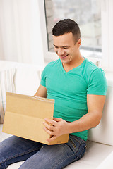 Image showing man with cardboard boxes at home