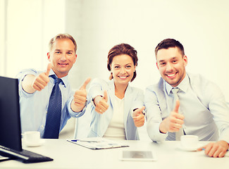 Image showing business team showing thumbs up in office