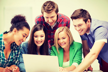 Image showing international students looking at laptop at school