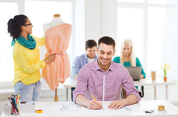 Image showing smiling fashion designers working in office