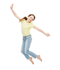 Image showing smiling little girl jumping