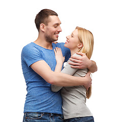 Image showing smiling couple hugging and looking at each other