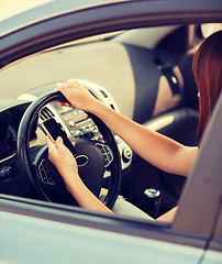 Image showing woman using phone while driving the car