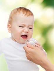 Image showing crying baby with dummy