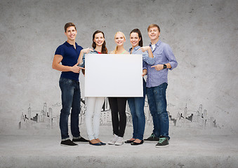 Image showing group of smiling students with white blank board