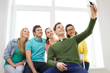 Image showing five smiling students taking picture with camera