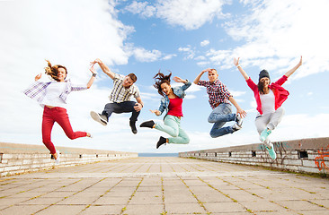 Image showing group of teenagers jumping