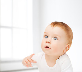 Image showing curious baby looking up