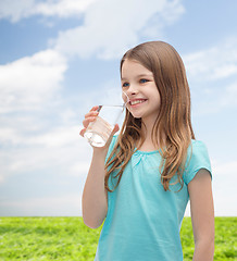 Image showing smiling little girl with glass of water