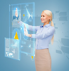 Image showing smiling businesswoman working with virtual screen