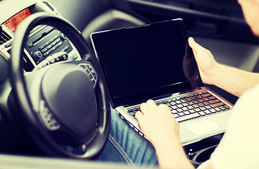 Image showing man using laptop computer in car