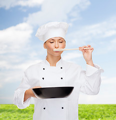 Image showing smiling female chef with pan and spoon