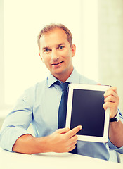 Image showing smiling businessman with tablet pc in office