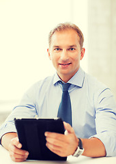 Image showing businessman with tablet pc in office