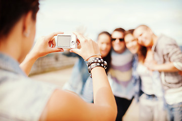 Image showing close up of female hands holding digital camera