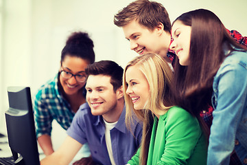 Image showing students looking at computer monitor at school