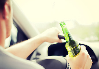 Image showing man drinking alcohol while driving the car