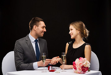 Image showing man proposing to his girlfriend at restaurant