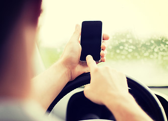 Image showing man using phone while driving the car