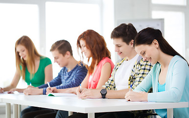 Image showing smiling students with textbooks at school