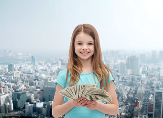 Image showing smiling little girl with dollar cash money