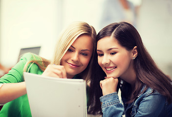 Image showing student girls pointing at notebook at school