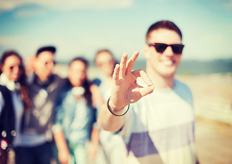 Image showing close up of male hand showing ok sing with fingers