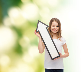 Image showing smiling little girl with blank arrow pointing up