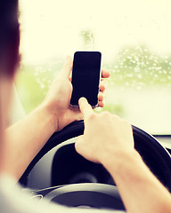 Image showing man using phone while driving the car