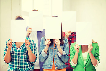 Image showing students covering faces with blank papers