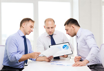Image showing serious businessmen with papers in office