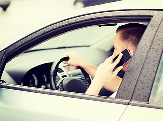 Image showing man using phone while driving the car