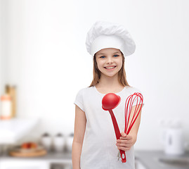 Image showing smiling girl in cook hat with ladle and whisk