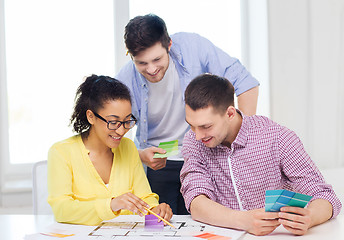 Image showing smiling interior designers working in office