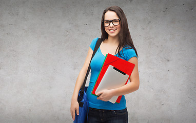 Image showing smiling student with bag, folders and tablet pc