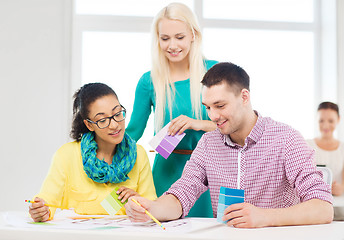 Image showing smiling interior designers working in office