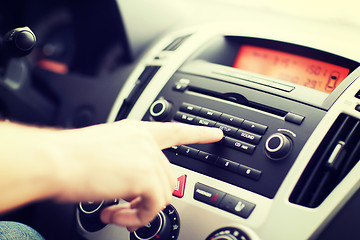 Image showing man using car audio stereo system